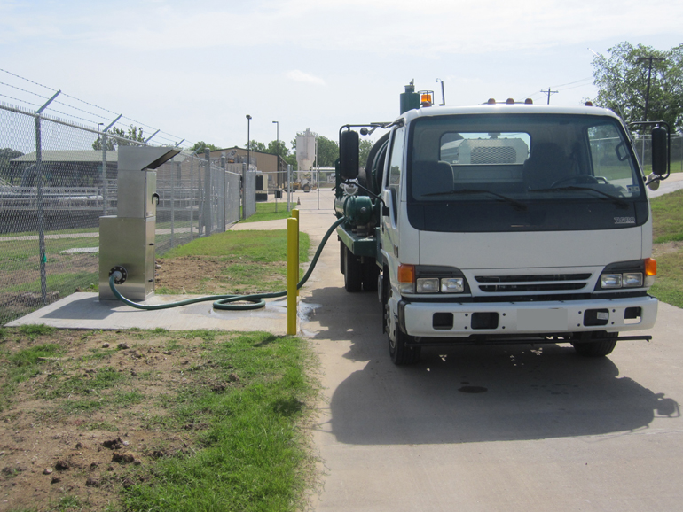 A hauler fills their truck with reclaimed water from the Brenham, Texas Portalogic water filling station
